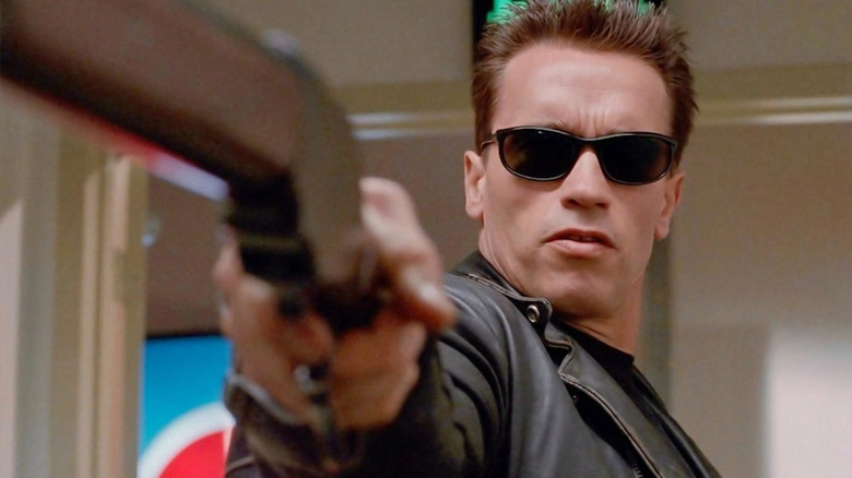 Arnold Schwarzenegger as the Terminator, aiming a shot gun in Terminator 2: Judgment Day.