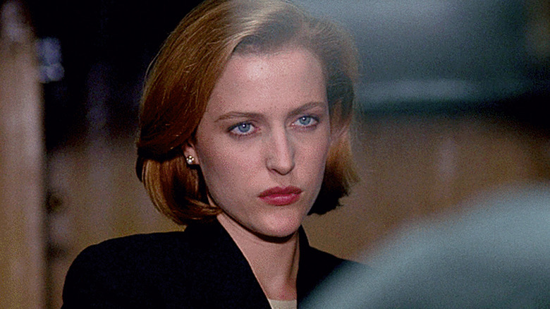 Gillian Anderson as Dana Scully, scowling in The X-Files.