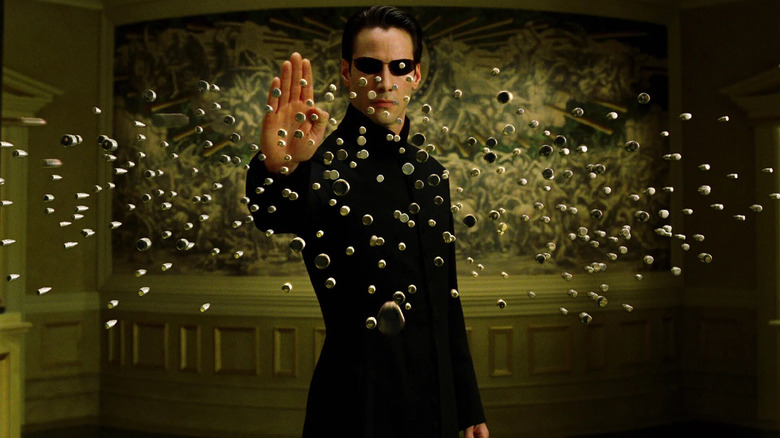 Keanu Reeves as Neo, stopping bullets in the air in The Matrix Reloaded