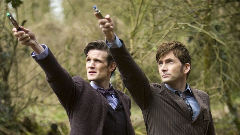Matt Smith and David Tennant as the 11th Doctor and the 10th Doctor holding their sonic screwdrivers in Doctor Who: The Day of the Doctor