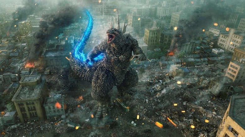 Godzilla stands in the rubble of a Japanese city in Godzilla Minus One