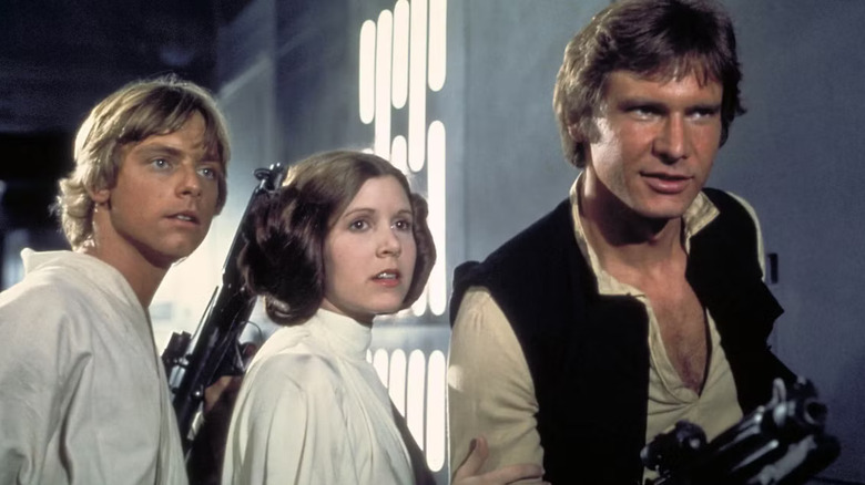 Mark Hamill, Carrie Fisher, and Harrison Ford as Luke Skywalker, Princess Leia Organa, and Han Solo as they escape the Death Star in Star Wars: A New Hope