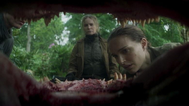 Lena (Natalie Portman) and Dr. Ventress (Jennifer Jason Leigh) looking into an animal's mouth in Annihilation