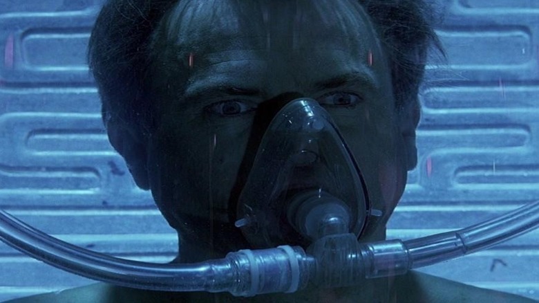 Dr. William Weir (Sam Neill) wearing a breathing apparatus in Event Horizon