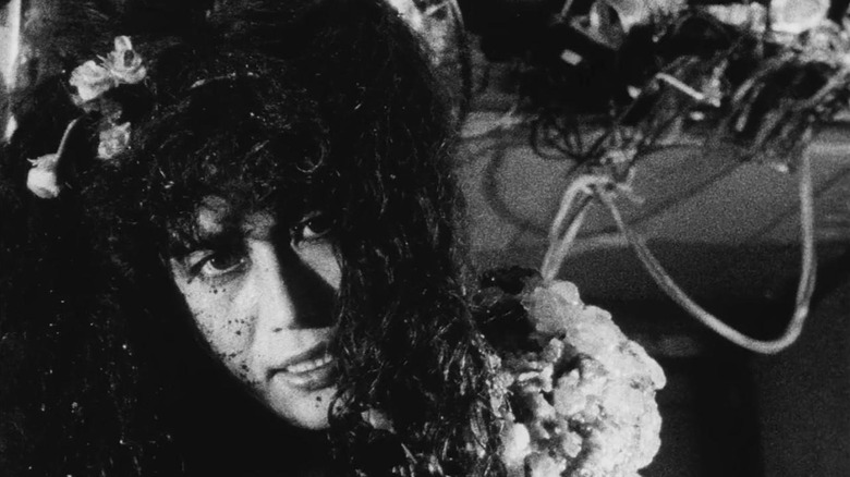 Salaryman's girlfriend (Kei Fujiwara) surrounded by machinery in Tetsuo: The Iron Man