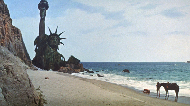 The wreckage of the Statue of Liberty sits on a beach in Planet of the Apes (1968)
