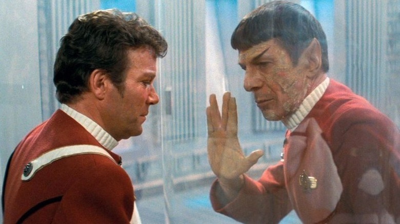 Spock (Leonard Nimoy) salutes to Jim Kirk (William Shatner) through glass in Star Trek II: The Wrath of Khan