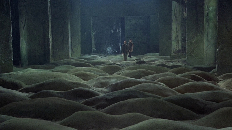 The Writer (Anatoly Solonitsyn) and the Professor (Nikolai Grinko) standing in the Sand Room, a room full of small sand dunes, in Stalker.