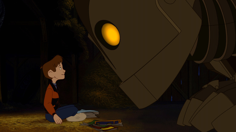 Eli Marienthal as Hogarth Hughes being closely peered at by Vin Diesel as The Iron Giant in The Iron Giant.