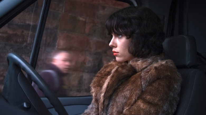 Scarlett Johansson as the Female in Under the Skin, sitting in a van