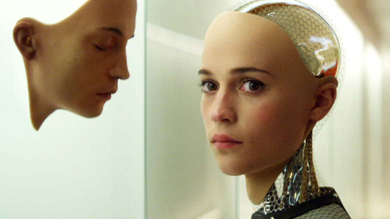 Alicia Vikander as Ava, standing near a face mold in Ex Machina.
