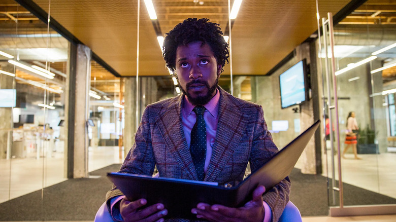 LaKeith Stanfield as Cassius Green, looking up from a folder in Sorry to Bother You.
