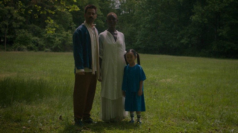 Jake (Colin Farrell), Kyra (Jodie Turner-Smith), and Mika (Malea Emma Tjandrawidjaja) standing in a field in After Yang
