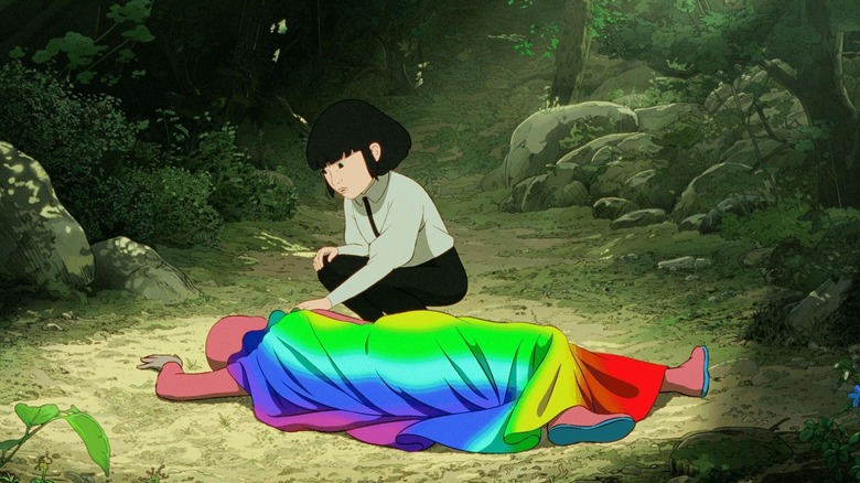 Iris (Romy Fay) finding Arco (Juliano Krue Valdi) in a rainbow cape on the ground in Arco
