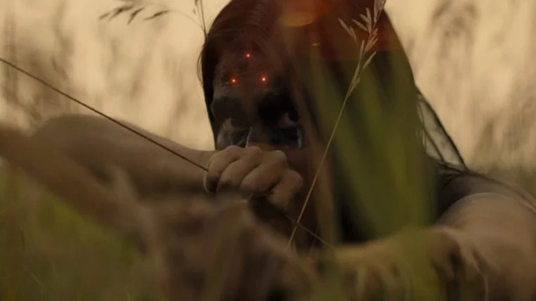 Naru (Amber Midthunder) with sights on her forehead in Prey