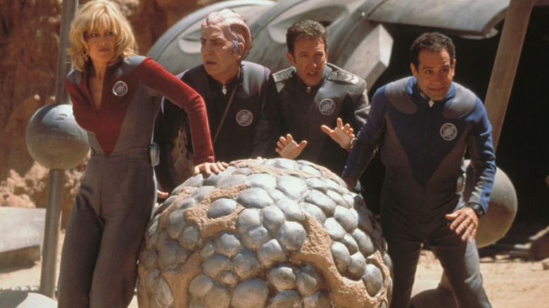 The Galaxy Quest crew pushs a sphere on an alien planet