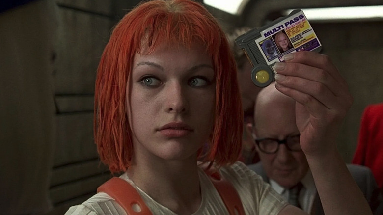 Milla Jovovich as Leeloo, holding up her multi-pass in The Fifth Element
