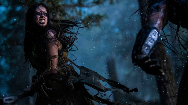 Amber Midthunder as Naru, fighting a Predator in Prey