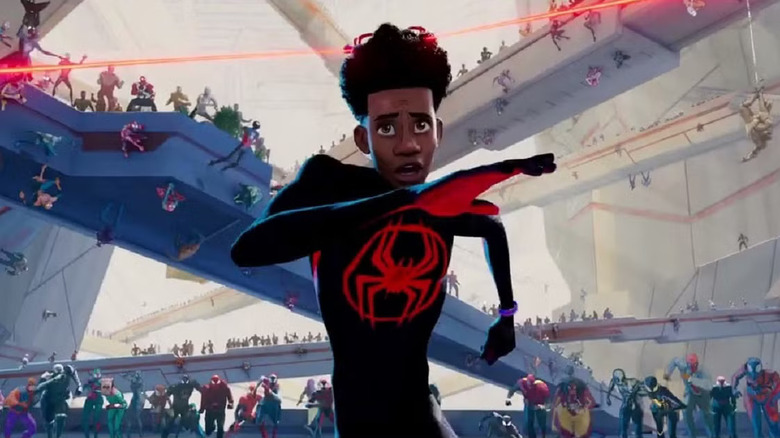 Shameik Moore as Miles running from a horde of other Spider-beings in Spider-Man: Across the Universe