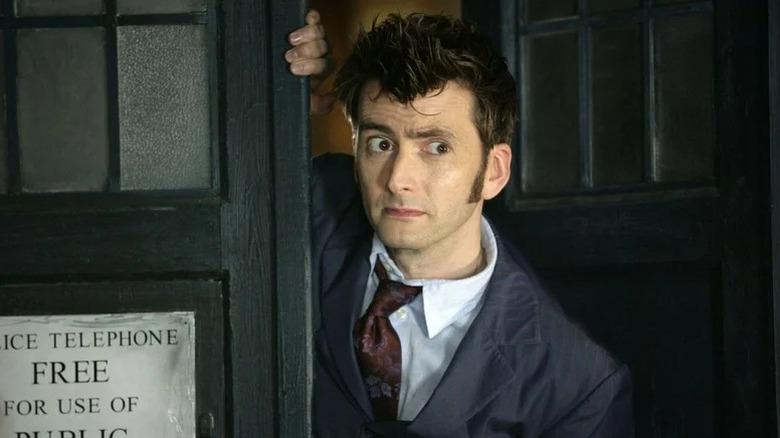 The Tenth Doctor (David Tennant) stares skeptically outside of the TARDIS in Doctor Who