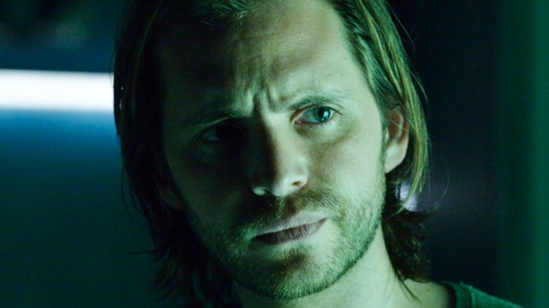Cole (Aaron Stanford) is green-hued and pensive on 12 Monkeys.