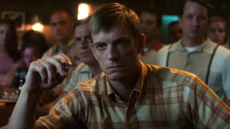 Joel Kinnaman as Edward Baldwin, angrily watching TV at a bar in For All Mankind.