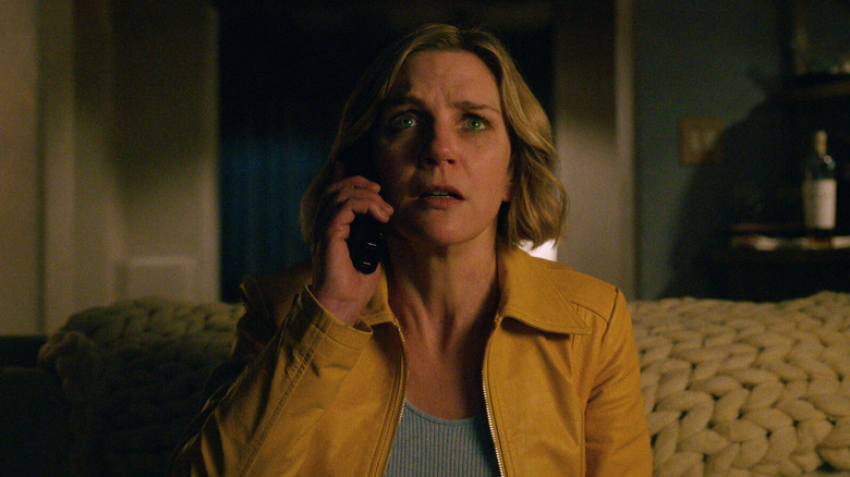 Rhea Seehorn as Carol Sturka, answering a phone call in awe in Pluribus.