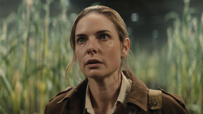 Rebecca Ferguson as Juliette Nichols, looking up in a synthetic field in Silo.
