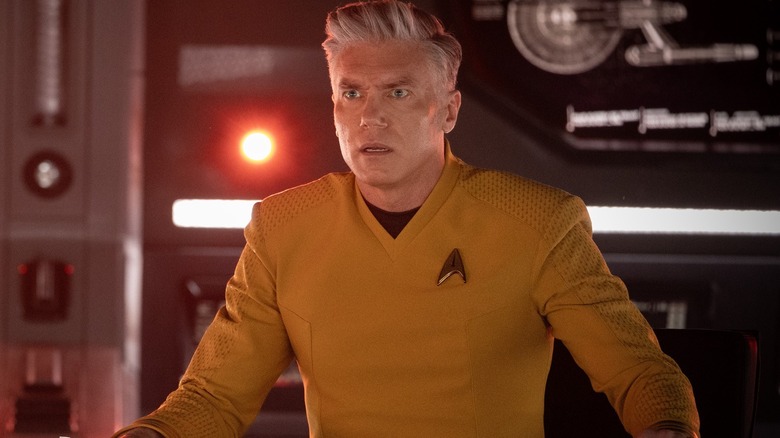 Anson Mount as Christopher Pike, sitting in the pilot's chair in Star Trek: Strange New Worlds.