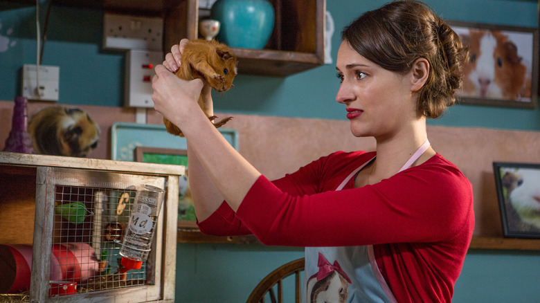 Fleabag (Phoebe Waller-Bridge) holding a Guinea pig in Fleabag