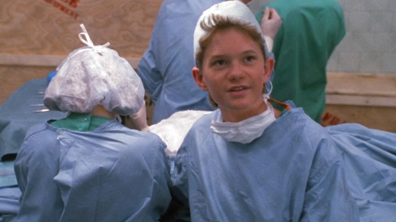 Neil Patrick Harris as Doogie Howser, wears scrubs in a surgical room on Doogie Howser, M.D.