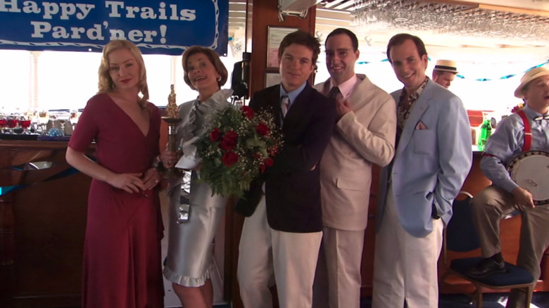 Portia de Rossi, Jessica Walter, Jason Bateman, Tony Hale, and Will Arnett as Lindsay, Lucille, Michael, Buster, and GOB Bluth celebrating the Bluth patriarch's retirement on a boat in Arrested Development