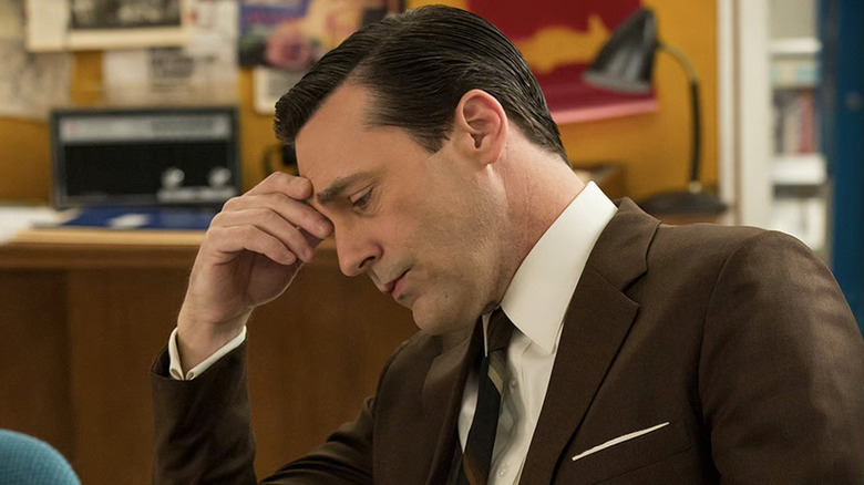 Jon Hamm as Don Draper, looking down in Mad Men.