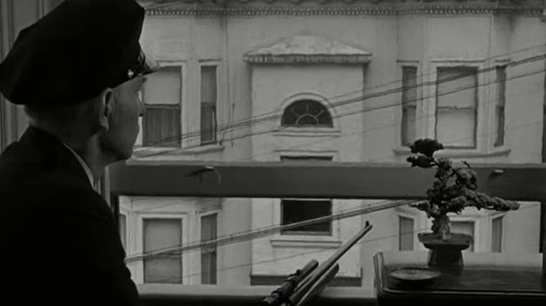 A policeman on the lookout for the sniper in The Sniper