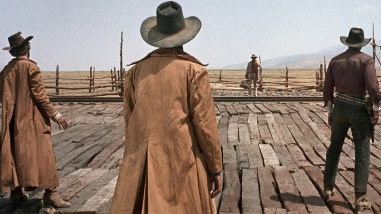 Charles Bronson as Harmonica, facing down three gunmen in Once Upon a Time in the West
