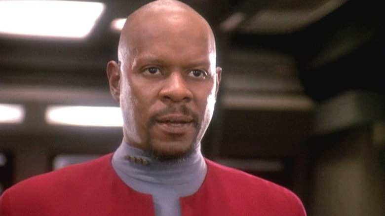 Benjamin Sisko (Avery Brooks) stands speaking in Star Trek: Deep Space Nine