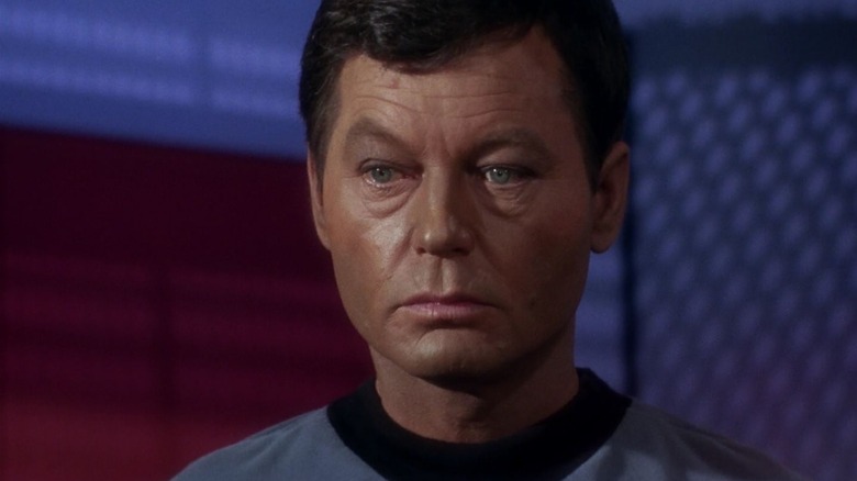 Leonard McCoy (DeForest Kelley) raises an eyebrow warily in Star Trek: The Original Series