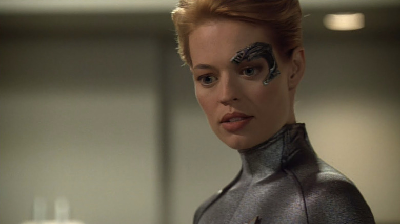 Seven of Nine (Jeri Ryan) stands speaking in Star Trek: Voyager