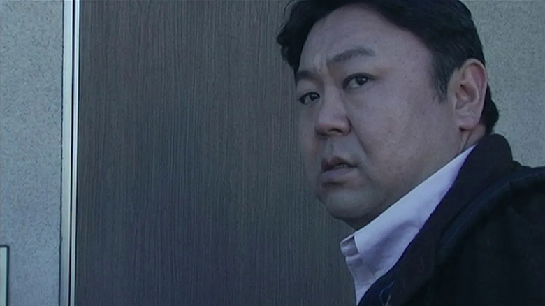 Masafumi Kobayashi as Jin, opening a door to a nightmare in Noroi The Curse