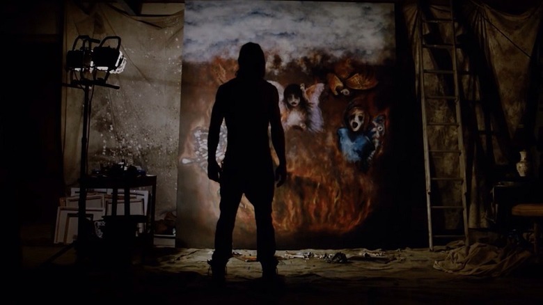 Ethan Embry as Jesse, surveying his creepy art in The Devil's Candy