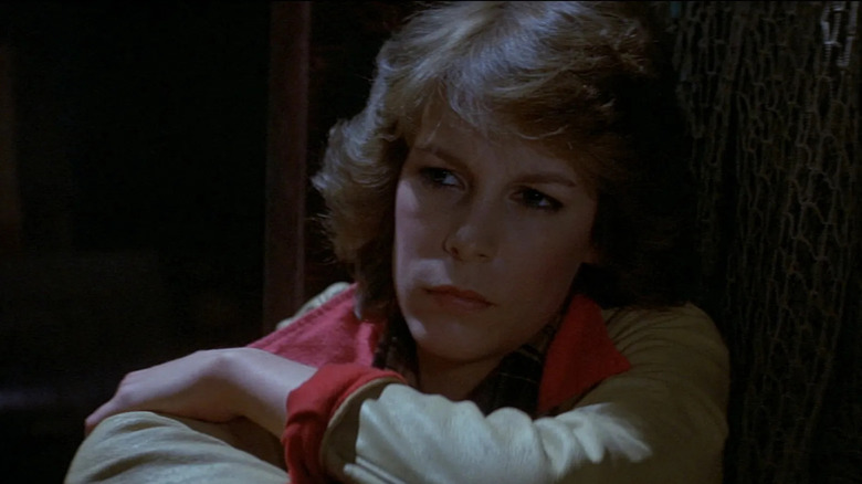 Jamie Lee Curtis as Liz, about to get scared by an arm in The Fog