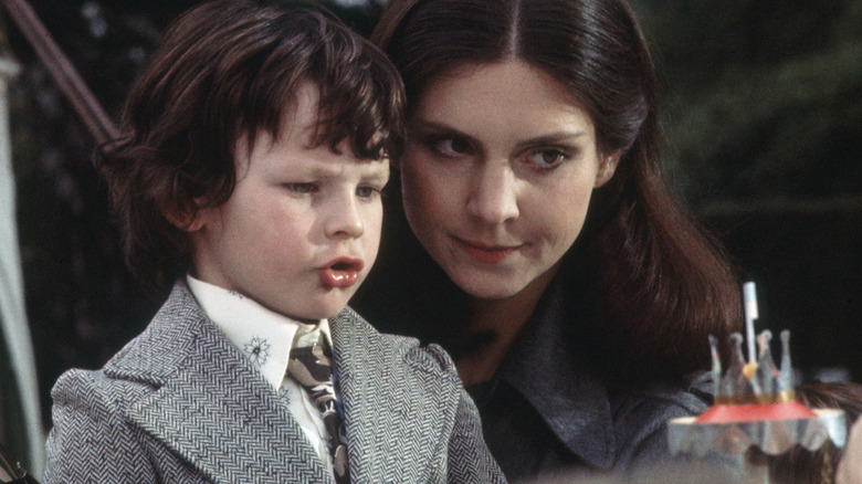 Harvey Stephens as Satan's son and Holly Palance as the nanny, making a devilish wish in The Omen