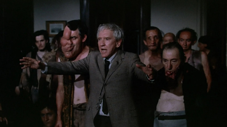 Burgess Meredith as Charles with friends, trying to spread evil in The Sentinel