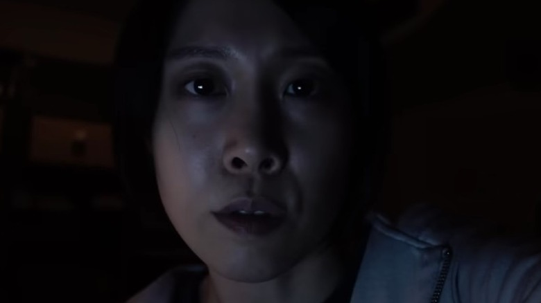 Woman looks scared at screen