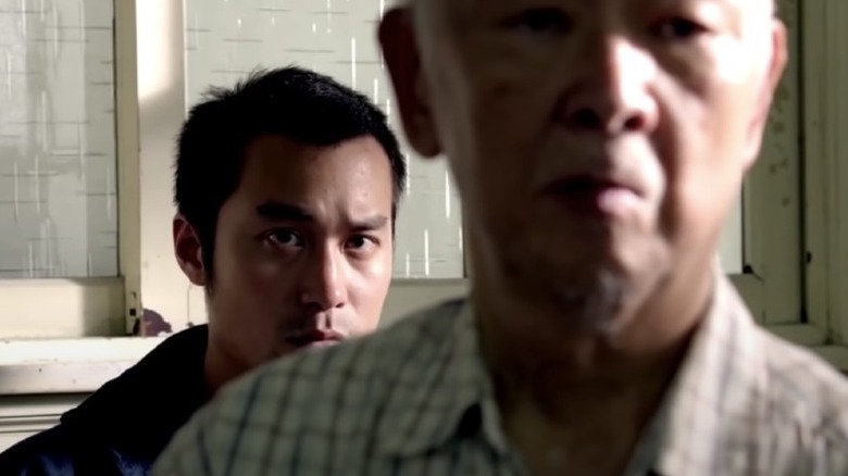 Young man stalking elderly man