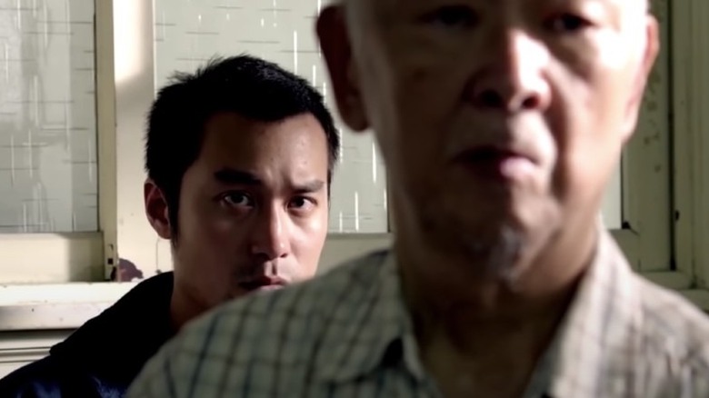 Young man stalking elderly man
