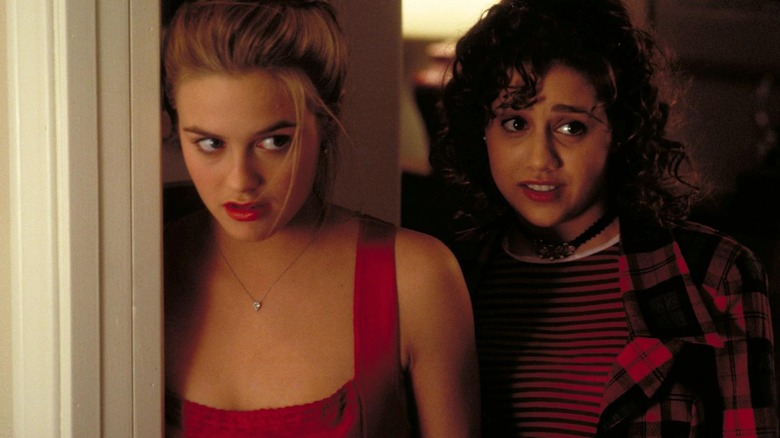 Alicia Silverstone as Cher and Brittany Murphy as Tai, overhearing something in Clueless