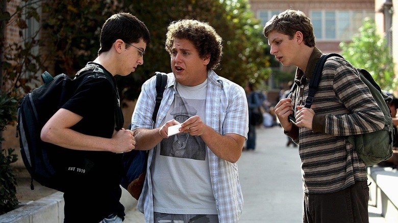 Christopher Mintz-Plasse as Fogel, Jonah Hill as Seth, and Michael Cera as Evan, debating fake ID quality in Superbad