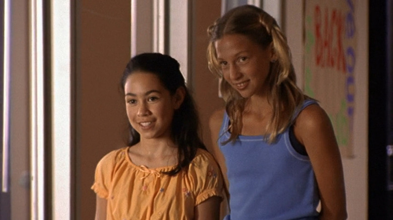 Manny (Cassie Steele) and Emma (Miriam McDonald) smiling at boy in Degrassi: The Next Generation