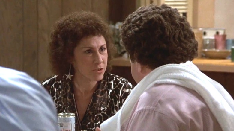 Rhea Perlman as Carla Tortelli arguing with George Wendt as Norm Peterson over the dinner table on Cheers
